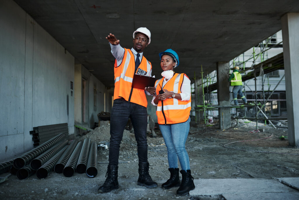 construction site architecture black people with clipboard teamwork maintenance contractor engineering employees manager with face mask safety discussion building checklist